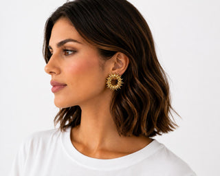 Model wearing Golden Sunburst Hoop Earrings — gold spiked sunburst statement earring
