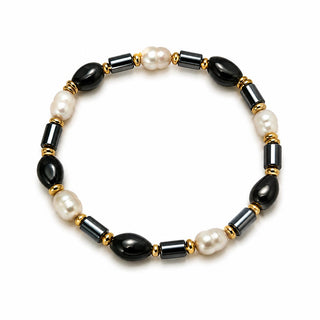 Black and faux pearl beaded stretch bracelet with gold-tone spacers, close-up