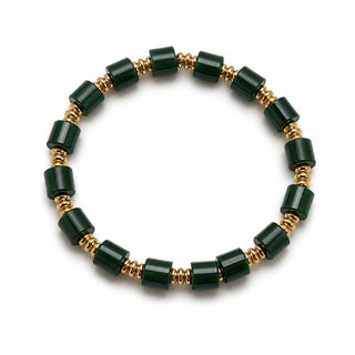 Green faceted bead stretch bracelet with gold-tone spacers, close-up
