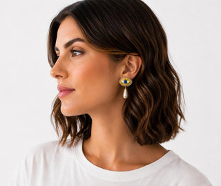 Model wearing Evil Eye Pearl Drop Earrings — gold evil eye stud with faux pearl drop
