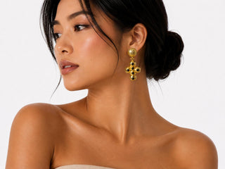 Model wearing Golden Cross Black Stone Earrings — gold cross drop earring with black stone accents