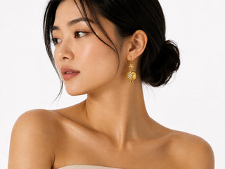 Model wearing Golden Pomegranate Pearl Earrings — gold pomegranate charm with faux pearl cluster