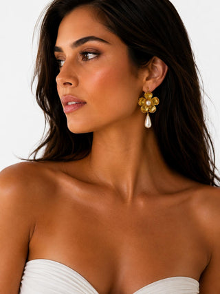 Model wearing Golden Flower Pearl Drop Earrings — gold flower earring with faux pearl center and teardrop