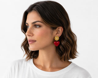 Model wearing Golden Medallion Heart Drop Earrings — gold filigree stud with red heart drop