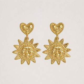 Golden Sun Heart Earrings — gold heart stud with sun medallion drop, close-up