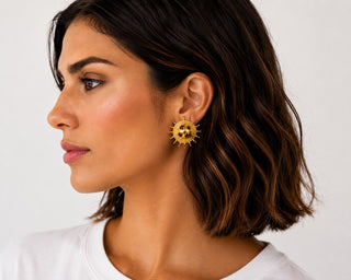Model wearing Golden Sun Medallion Gemstone Earrings — gold sun medallion stud with gemstone-tone center